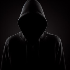 Person in a hood on dark background