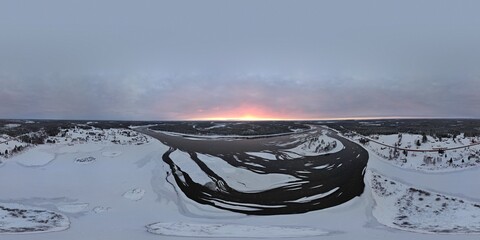Winding river under a glowing twilight sky in snowy Lovikka.