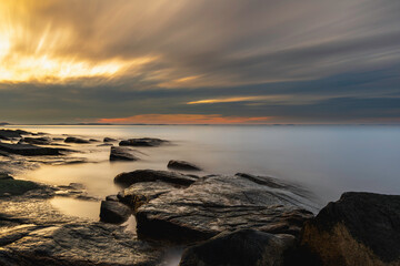 Sunset at a rocky shore in Rockport MA