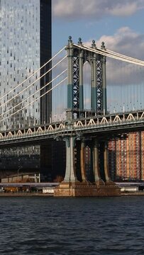manhattan bridge with cars driving in the background (famous nyc landmark in brooklyn over the hudson river) transport