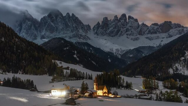 Cinematic starry time lapse Italia Dolomites Dolomiti Val di Funes Italy first snowfall early winter late autumn fall clouds St Maddalena Magdalena Catholic Church iconic photographed still Bolzano
