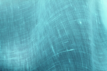 ターコイズブルーの粗いリネン生地、紫外線を透過したようなレタッチ・色加工した画像。