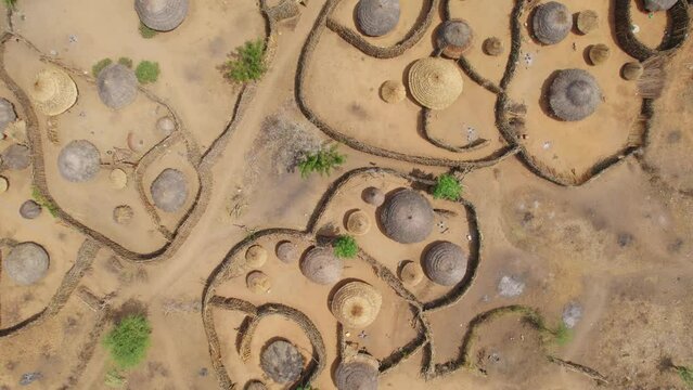 Rural and typical circular village of Nakapelimoru, Uganda in Africa. Aerial top-down view