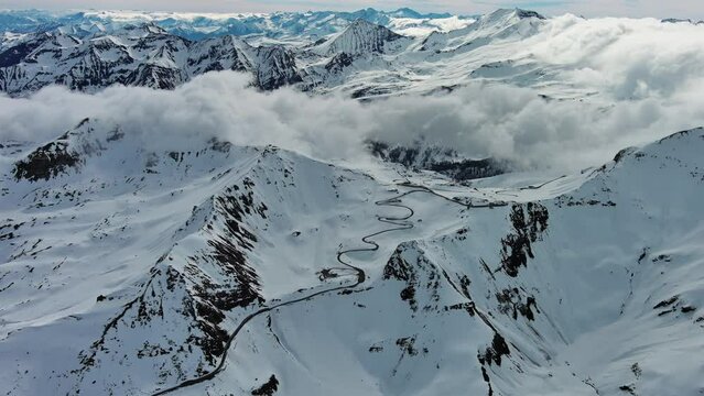 Aerial view of Grossgloknershtrasse in snow. Great high mountain road near Grossglokner mount in Austrian Alps, 4k