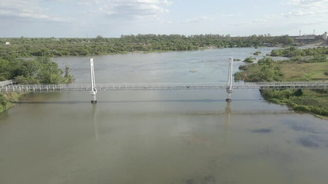 Bridge over the river leading to a natural reserve for bird watching in Termas de Rio Hondo, Santiago del Estero, Argentina.