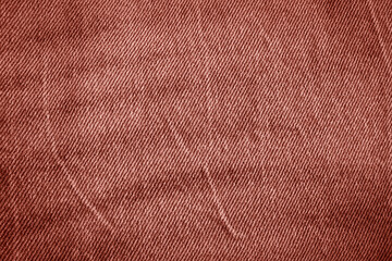 Fototapeta premium Texture of crumpled red jeans. 