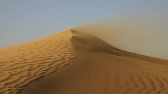 Sand blowing over large sand dunes in wind, Sahara desert, 4k