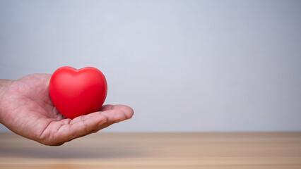 Fototapeta premium Good health and insurance concept, health insurance concept. Human hand holding red heart.