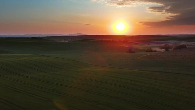 Aerial view of amazing wavy hills with agricultural fields at sunset. South Moravia region, Czech Republic, Europe, 4k
