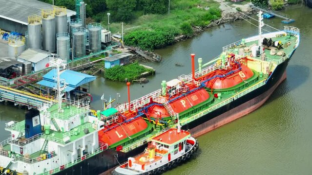 The gas tanker rests gracefully in the harbor, a silent behemoth awaiting its next voyage to power the world. Fueling our world with natural gas power. Harnessing gas for clean energy solutions.
