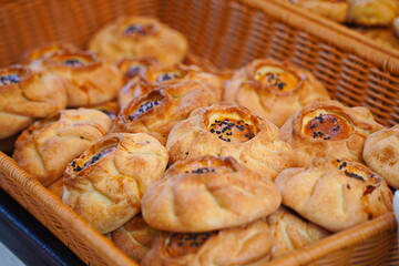 Puff pastry samosa with meat filling and sesame seeds.