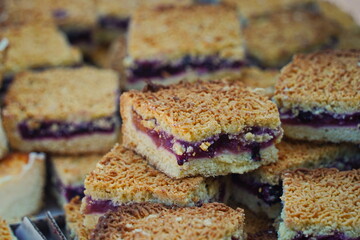 Slices of sweet pie with filling on the table.