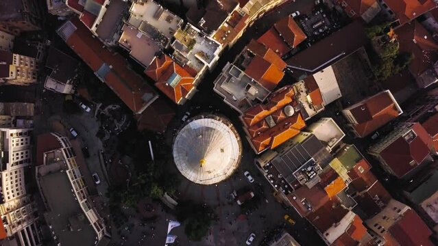 Aerial birdseye forward shot of Beyoglu district passing over Galata tower