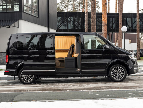 Novosibirsk, Russia -  November 10  , 2023:  black Volkswagen Multivan, open multivan with a luxurious interior for a family with expensive comfortable leather seats, lighting and other amenities