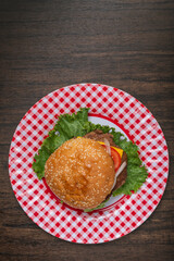 Homemade hamburger on a wooden table.