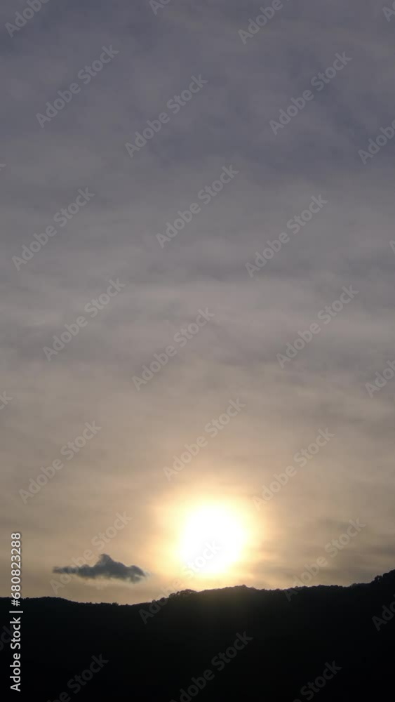 Wall mural twilight and dawn sky with cumulus cloud vertical time lapse in an evening.