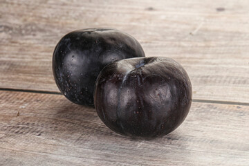 Two ripe sweet black plums