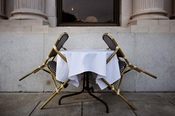 A restaurant has added outdoor dining, but the tables are turned to avoid passersby from sitting...