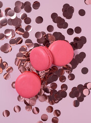 Pink french macarons with pink confetti, top view