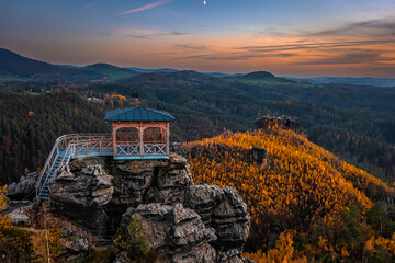 Jetrichovice, Czech Republic - Aerial view of Mariina Vyhlidka (Mary's view) lookout with a beautiful Czech autumn landscape and colorful golden sunset sky in Bohemian Switzerland region