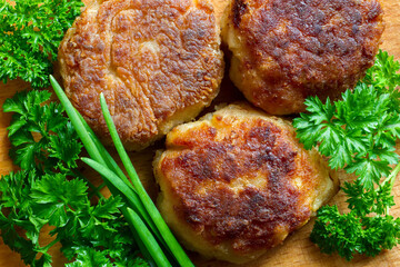 Meat balls with herbs close-up. Homemade meat cutlets on the background of wood.