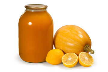 A jar of natural pumpkin juice. Ingredients for canned juice. Fresh pumpkin and lemons. Organic pumpkin juice on a white background.