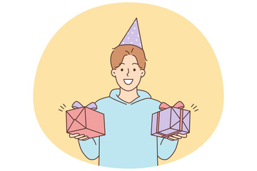 Smiling man holding birthday presents in hands