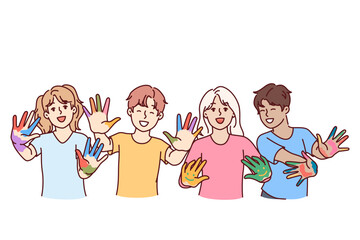 Obraz premium Childrens artists with palms smeared with paints rejoice at opportunity to draw and express creativity. Happy hildrens boys and girls in primary school are happy thanks to art lessons
