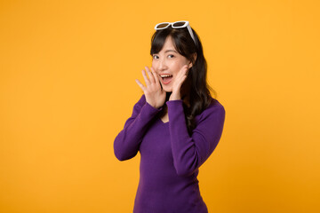 In a vibrant scene against a yellow background, a young woman in a purple shirt and sunglasses...