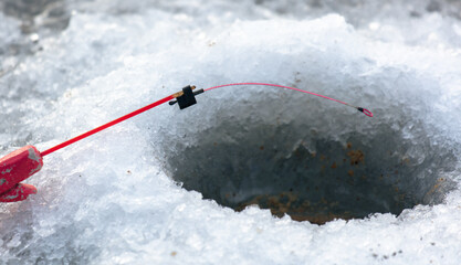 Fishing rod on ice in winter. Ice fishing