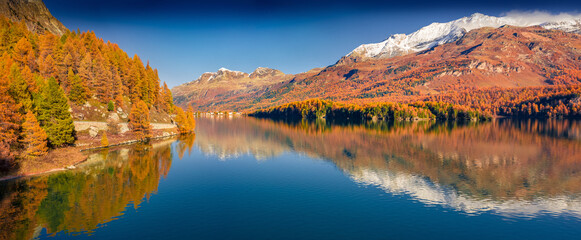 Panoramic autumn view of Sils Lake. colorful morning view of Swiss Alps, Maloja Region, Upper Engadine, Switzerpand, Europe. Beauty of nature concept background.