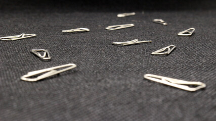 Close up of paper clips scattered