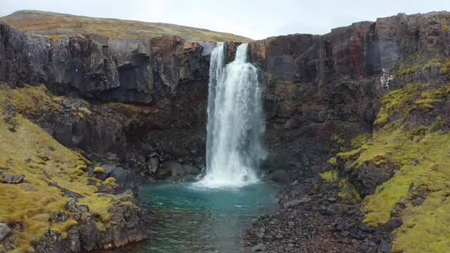 4k drone flight point of view (Ultra High Definition) of Gufufoss (Gufu Waterfall). Astonishing midnight sun scene of typical volcanic landscape of Iceland. Beauty of nature concept background.
