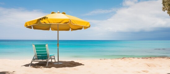 Beach chair with umbrella and beautiful tropical sand beach and blue sea.