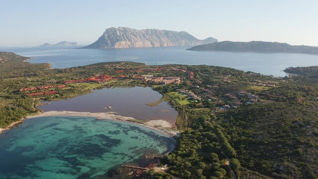 4k drone flight moving to the side footage (Ultra High Definition) of Salina Bamba beach with Tavolara mountain on background. Incredible morning view of Sardinia island, Italy, Europe.