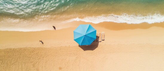 Top view an umbrella and beautiful tropical sand beach and blue sea.