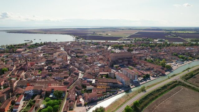 Comacchio, Italy, drone move down orbit view of urban infrastructure, little Italian city, sunny weather