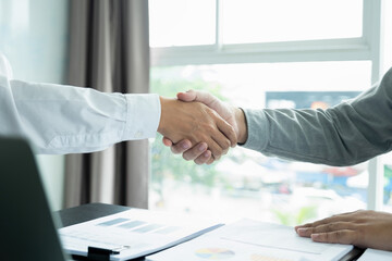 Obraz na płótnie Canvas Businessmen giving handshake after working.