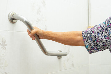 Asian elderly woman use toilet bathroom handle security, healthy strong medical concept. - obrazy, fototapety, plakaty
