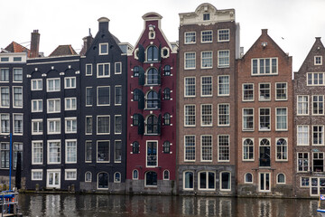 Fototapeta premium Typical gabled houses on Damrak street in Amsterdam, Holland, Netherlands