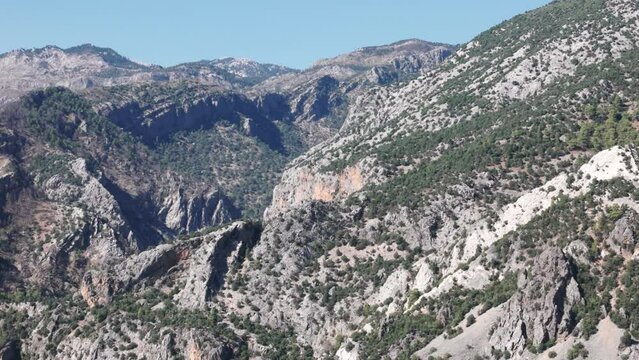 Exposed white grey rocks dotted with low shrubs in Taurus mountains Turkey