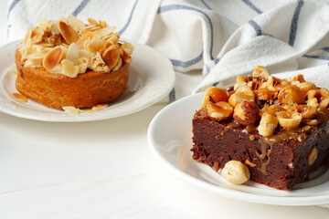 Almond tart and brownie on white background