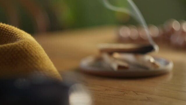 Smoking aromatic incense in modern home, changing focus view