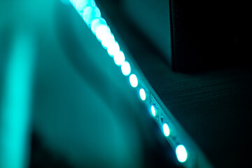 LED strip shines along the edge of the table