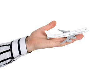 A man's hand in a classic shirt holds a model of a passenger airliner. Conceptual image.