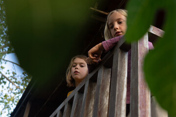 Two children leaning over a railing