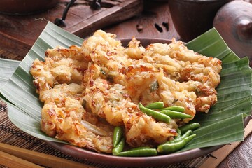 Bakwan sayur is Indonesian deep fried vegetable fritters. Found nation wide, mostly sold by street food vendors, the most popular version uses a mix of cabbage, carrot, and mung bean sprouts.