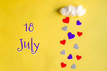 18 july day of month, colorful hearts rain from a white cotton cloud on a yellow background. Valentine's day, love and wedding concept