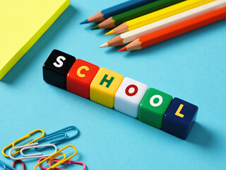 Schooling, teaching and education concept. The word school on colorful cubes