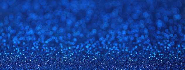 Blurred navy blue sparkling background from small sequins, macro. Shiny sapphire bokeh of backdrop. - obrazy, fototapety, plakaty